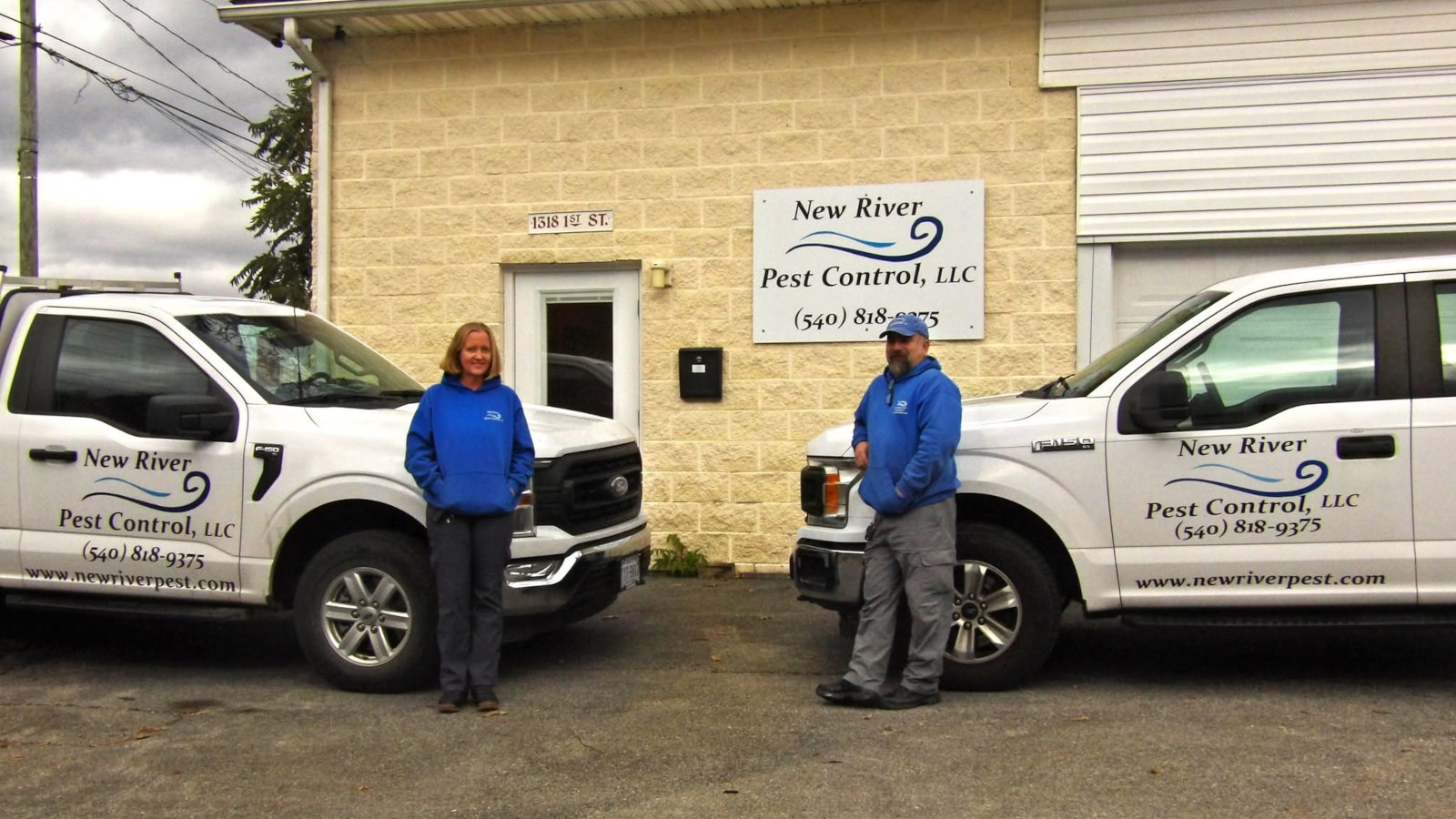 Aaron Gleeson and Zosha McKinney in front of New River Pest Control trucks at 1318 West Main St, Radford VA